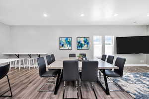 Dining space with wood finished floors, recessed lighting, and baseboards
