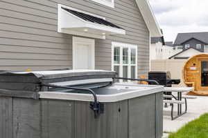 View of patio with a hot tub