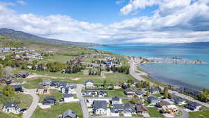 Aerial overview of property's location with a water and mountain view and nearby suburban area