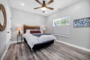 Bedroom with wood finished floors, recessed lighting, baseboards, and ceiling fan