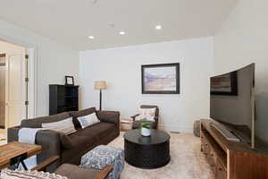 Living area with recessed lighting and baseboards
