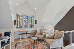 Living area featuring carpet, high vaulted ceiling, recessed lighting, and baseboards