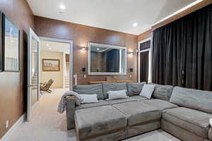 Living area featuring carpet floors, baseboards, and recessed lighting