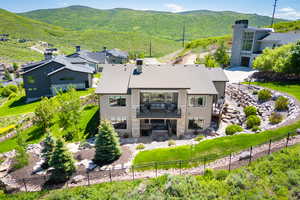 Aerial view of property and surrounding area featuring mountains