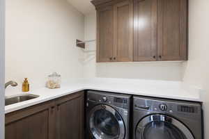 Laundry room with cabinet space and independent washer and dryer