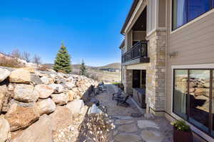 View of patio with a balcony and a mountain view