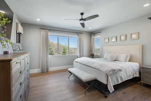 Bedroom featuring baseboards, recessed lighting, dark wood-type flooring, and a ceiling fan