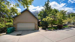Garage with a mountain view and concrete driveway