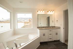 Full bath with a bath and double vanity