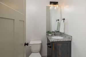 Half bath featuring toilet and vanity