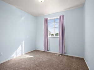 Unfurnished room with carpet floors and baseboards