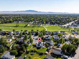Aerial view of property's location featuring a mountain backdrop and nearby suburban area
