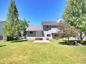 Rear view of house featuring french doors, a patio area, and a chimney