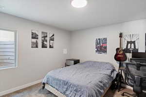 Carpeted bedroom with baseboards