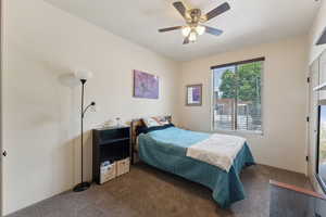 Carpeted bedroom with ceiling fan