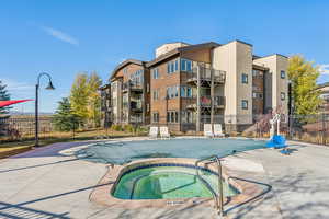 Community pool with a hot tub and a patio area