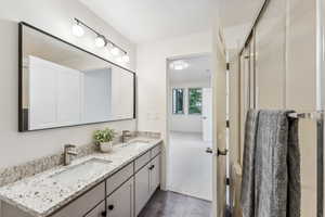 Bathroom with double vanity and tile patterned flooring