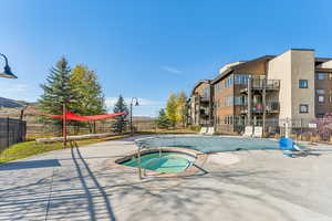 Community pool with a hot tub and a patio