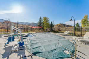 View of pool featuring a fenced backyard, a mountain view, and a patio area