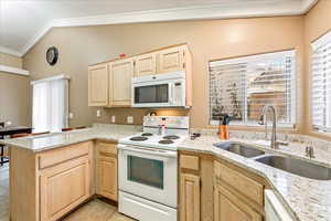 Even chores feel better with a view—kitchen windows bring in natural light and charm.
