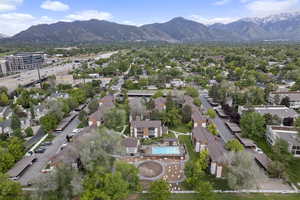 Aerial view of property's location with a mountainous background, nearby suburban area, and a pool area