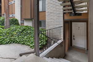 View of exterior entry featuring brick siding