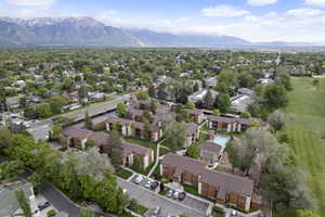Aerial view of property and surrounding area with a mountainous background and nearby suburban area