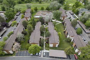 Aerial overview of property's location featuring nearby suburban area and a golf course