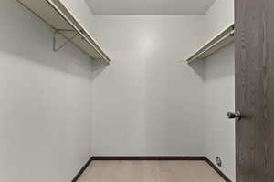 Spacious closet with light wood-style flooring