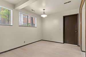 Spare room with light wood-style flooring and baseboards