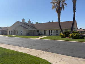 Ranch-style house with french doors, a front lawn, and a chimney