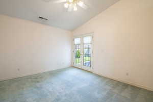 Unfurnished room with ceiling fan, baseboards, carpet flooring, high vaulted ceiling, and french doors