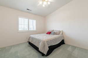 Bedroom with carpet floors, baseboards, a ceiling fan, and lofted ceiling