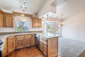 Kitchen featuring a sink, appliances with stainless steel finishes, a peninsula, and healthy amount of natural light