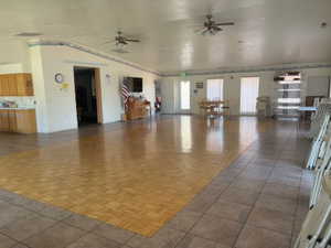 Unfurnished living room featuring ceiling fan