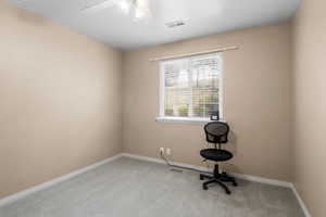 Unfurnished office with carpet, a ceiling fan, and baseboards