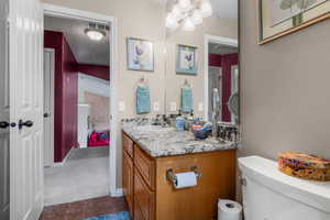 Bathroom with vanity, tile patterned flooring, and toilet
