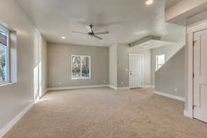 Unfurnished living room featuring light carpet, ceiling fan, recessed lighting, and baseboards