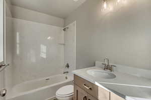 Bathroom featuring vanity, toilet, and shower / bath combination