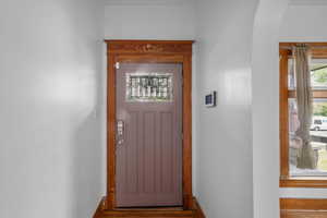 Doorway to outside with baseboards and arched walkways