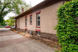 View of home's exterior with a chimney and brick siding