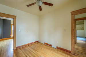 Empty room with light wood-style floors, ceiling fan, and baseboards