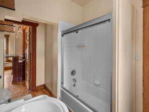 Full bathroom with a sink, wood finished floors, and tub / shower combination