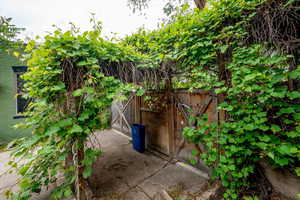 View of patio featuring a gate
