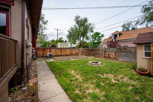 View of yard with central AC and a fire pit