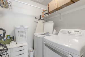 Laundry room featuring washer and clothes dryer