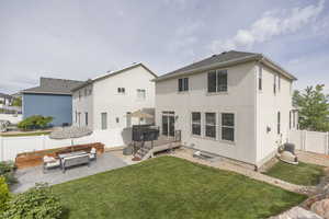 Back of property featuring stucco siding, a patio, a deck, and central AC unit