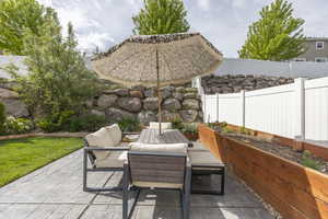 Fenced backyard with a patio and outdoor lounge area