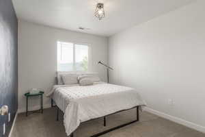 Bedroom with light carpet and baseboards