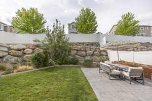 View of yard with a patio area and outdoor dining area